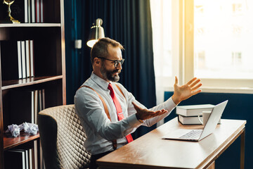 Authentic A bearded businessman is discussing business on the facetime in business negotiations. Video Call. Face time and Conference call concept