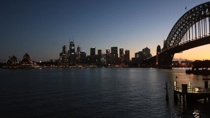 Sticker - Dark timelapse of city of Sydney CBD waterfront across Harbour & bridge–4k.
