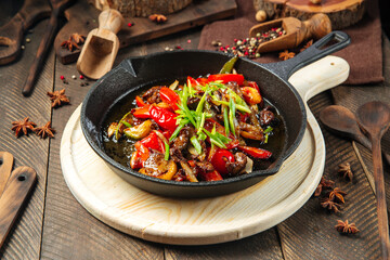 Wall Mural - Roasted beef with vegetables in cast iron pan