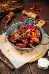 Wall Mural - Roasted chicken in a pan on the wooden table