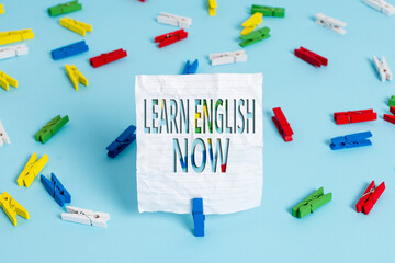 Poster - Writing note showing Learn English Now. Business concept for gain or acquire knowledge and skill of English language Colored clothespin papers empty reminder blue floor officepin