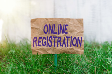Fototapete - Word writing text Online Registration. Business photo showcasing System for subscribing or registering via the Internet Crumpled paper attached to a stick and placed in the green grassy land