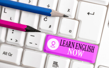 Poster - Conceptual hand writing showing Learn English Now. Concept meaning gain or acquire knowledge and skill of English language Colored keyboard key with accessories arranged on copy space