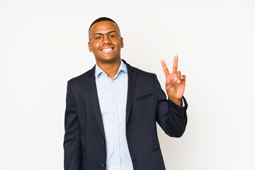 Wall Mural - Young business latin man isolated on white background showing victory sign and smiling broadly.