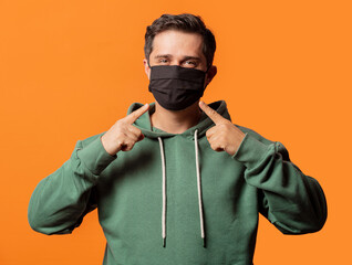 Wall Mural - guy in face mask and green hoodie