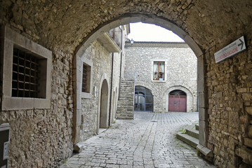 A narrow street among the old houses of San Marco dei Cavoti, a small town in the province of Benevento, Italy.