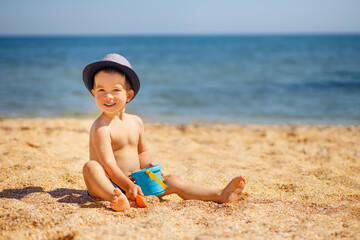 Wall Mural - little boy playing on the sea beach