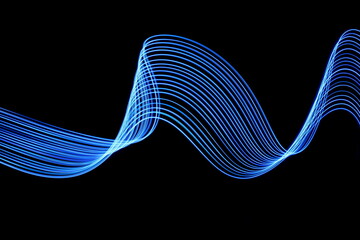 Wall Mural - Long exposure photograph of neon blue colour in an abstract swirl, parallel lines pattern against a black background. Light painting photography