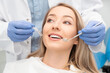 © Proxima Studio - Woman having teeth examined at dentists