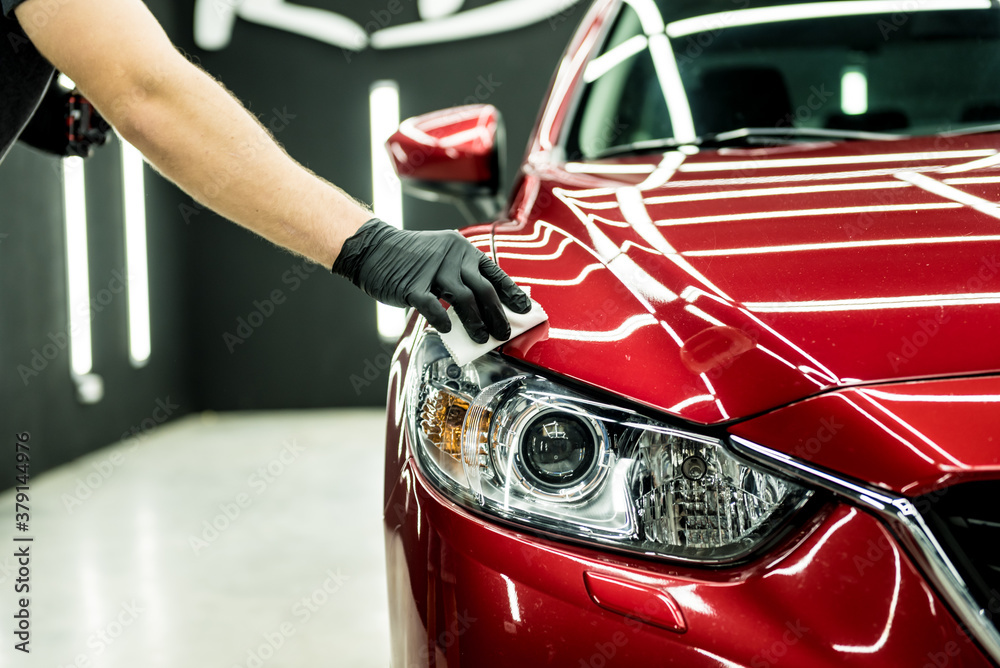 Car service worker applying nano coating on a car detail. - obrazy, fototapety, plakaty 