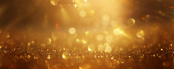 background of abstract gold and black glitter lights. defocused