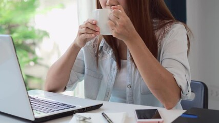 Wall Mural - Young woman taking a coffee break and relaxing at living room while working at home, Work from home concept