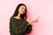 © Asier - Young chinese woman isolated on a pink background excited pointing with forefingers away.