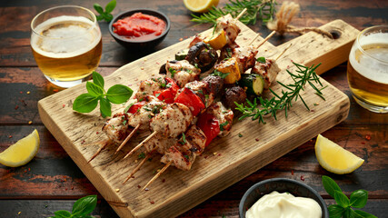 Wall Mural - Chicken kebab, BBQ, skewers with mushrooms, red sweet pepper, zucchini and beer. Party food