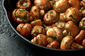 Wall Mural - Fried mushrooms with onion and garlic in iron cast pan