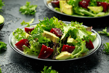 Wall Mural - Vegetarian avocado and beet salad in plate. Healthy vegan food