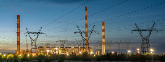 Wall Mural - High-voltage pylons running straight from the power plant against the background of the night sky - panorama