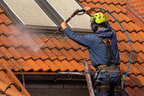 Fototapeta Do pokoju - worker washing the roof with pressurized water