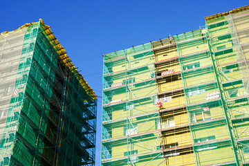 Wall Mural - scaffolding arround the house to install thermal insulation of the apartment building facade