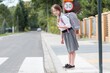 © Photographee.eu - Adorable girl with pigtails and a gray backpack is standing in front of a pedestrian crossing on a one-way street