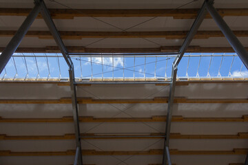 Wall Mural - Metal frame of the building with a sandwich panel of insulation on the wall. Construction of a new industrial building. Modern Insulation of the walls of the building panels of insulation.