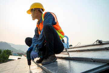 Poster - Construction worker with nail gun installing new roof in the building under construction.