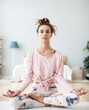 © BestForYou - Beautiful young woman working out at home, doing yoga exercises, sitting in Lotus pose, full length.