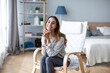 © BestForYou - Happy friendly woman in casual clothes in cozy chair at home.