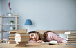 © BestForYou - Young woman student with many books sleeping.