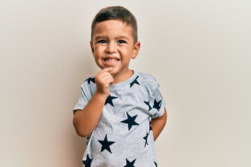 Adorable latin toddler wearing casual clothes smiling looking confident at the camera with crossed arms and hand on chin. thinking positive.