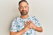 © Krakenimages.com - Handsome middle age man wearing casual clothes smiling with hands on chest, eyes closed with grateful gesture on face. health concept.