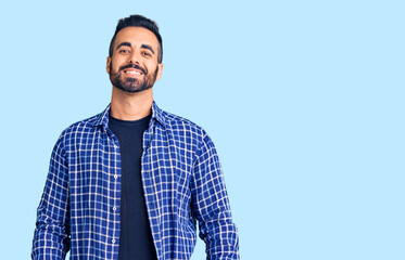 Young hispanic man wearing casual clothes with a happy and cool smile on face. lucky person.