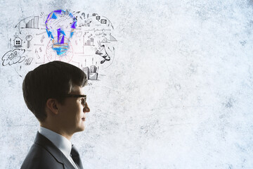 Wall Mural - Thoughtful businessman with glowing light bulb and business sketch