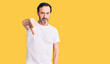 © Krakenimages.com - Middle age handsome man wearing casual t-shirt looking unhappy and angry showing rejection and negative with thumbs down gesture. bad expression.