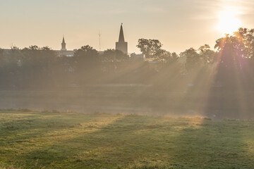 Poster - View of the city under the rays of the rising sun