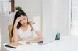 © NT_studio - Young asian woman headache during working on laptop computer with deadline on desk at home, business woman with failure exhausted and tired, stress and worried, frustrated and unsuccessful.