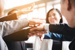 © chokniti - Large business team showing unity with their hands together, business success concept.