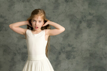 A little girl fixes her hair.The concept of beauty and fashion