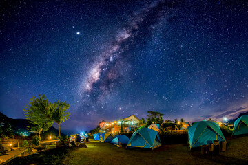 Wall Mural - tourist tent area on the mountain high at night in the sky with the milky way long exposure photogra