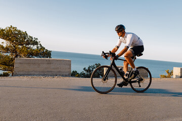 Wall Mural - Cycling sport athlete man riding on coastal road