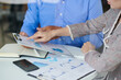 © DragonImages - Close-up image of bsuiness people pointing at report on clipboard when discussing monthly report at meeting