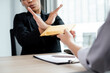 © Orathai - The businesswoman denies the money in proposed by his partner to bribe the concept of bribery and corruption