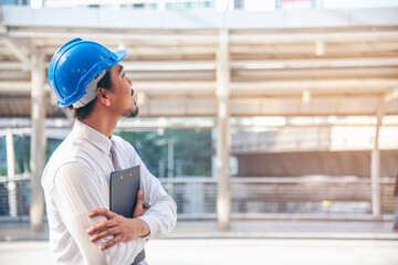 Construction engineer in Safety Suit Trust Team Holding White Yellow Safety hard hat Security Equipment on Construction Site. Hardhat Protect Head for Civil Construction Engineer. Engineering Concept