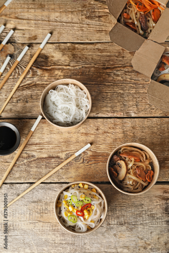 Bowls with tasty rice noodles on table