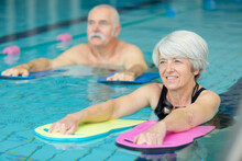 Elderly Doing Aqua Exercises In The Pool