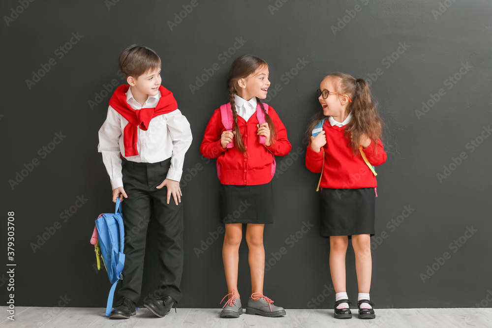 Little pupils near dark wall