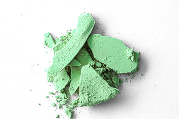 Green eye shadow powder as makeup palette closeup isolated on white background, crushed cosmetics and beauty textures