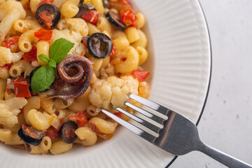 Poster - Pasta with anchovy, cauliflower, olives and tomatoes, Close up. Top view.