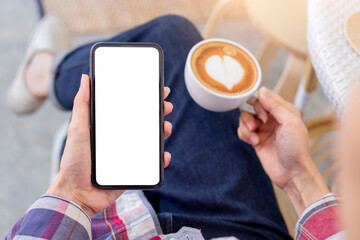 cell phone mockup blank white screen.woman hand holding texting using mobile on desk at coffee shop.background empty space for advertise.work people contact marketing business,technology