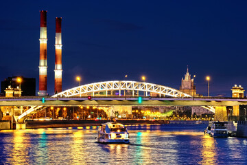 Wall Mural - downtown moscow city skyline at night. Architecture cityscape landmark with pleasure boat and railway bridge on foreground Russian ministry of foreign affairs skyscraper on background. Urban landscape